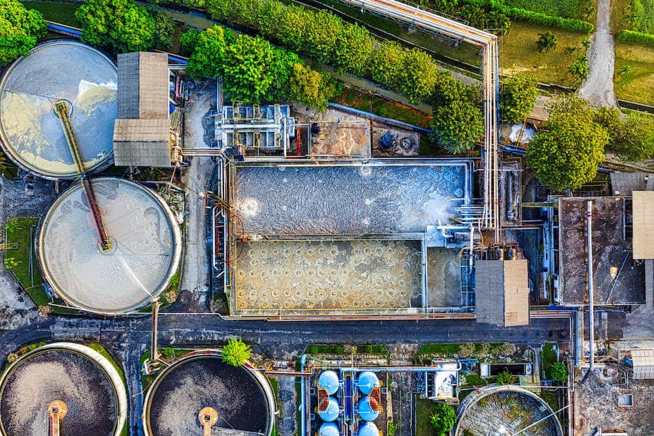 An image of a wastewater treatment plant with various tanks and equipment.